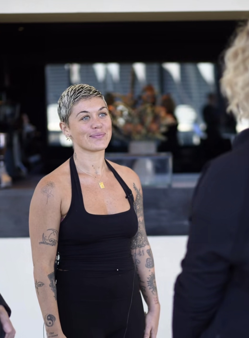 Sharleen smiling in conversation at a session