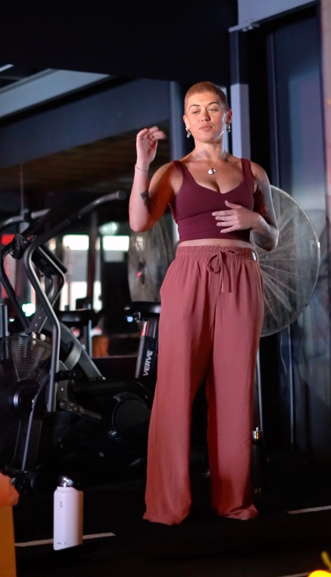 Sharleen teaching a nervous system workshop in a gym studio, gesturing mid-explanation